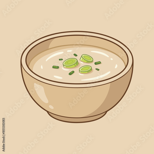 Creamy soup in a bowl with green garnish.