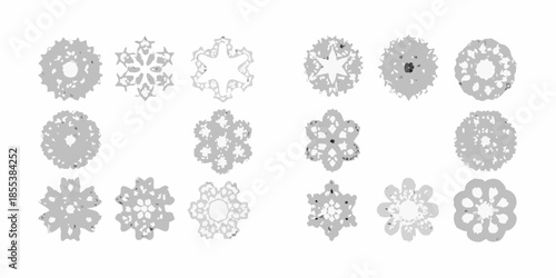 An assortment of intricately designed grayscale snowflake patterns on a white background