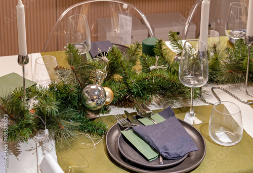 Table set up with festive Christmas ornaments in modern dining room interior