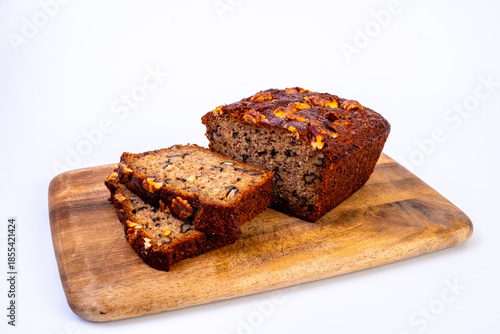 Delicious piece of banana and walnut cake on the wooden cutting board. Image close up view