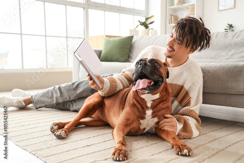 Young man with Boxer dog re...