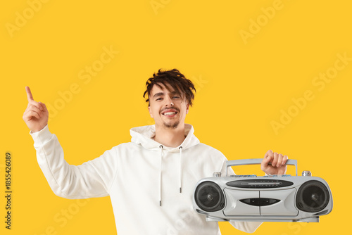 Young man with boombox poin...