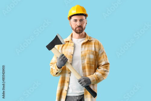 Male worker with ax on blue...