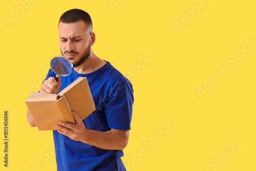 Young man with magnifier re...