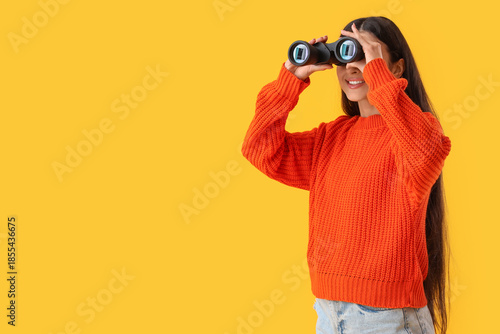 Young woman looking through...
