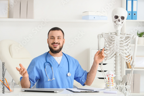 Male doctor with human skel...