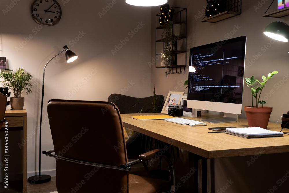 © Pixel-Shot - Programmer's desk with computer and glowing lamps in office at night © Pixel-Shot - Programmer's desk with computer and glowing lamps in office at night