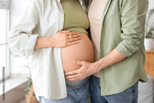 Happy pregnant couple huggi...