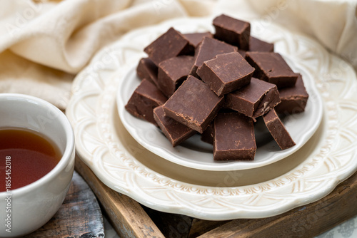 Chocolate fudge, freshly made small squared of pure fudge. Place and coffee or tea setting with a decadent dessert. 