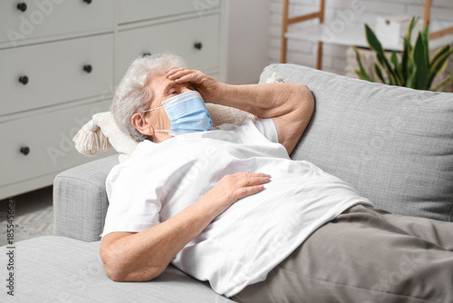 Sick elderly woman in medic...