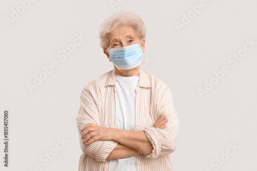 Elderly woman in medical ma...