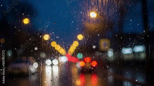 Rainy Night City Drive with Blurred Car Lights and Wet Windshield.
