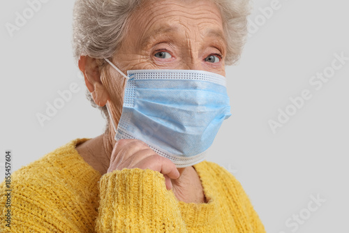 Elderly woman in medical ma...