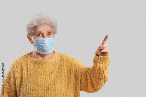 Elderly woman in medical ma...