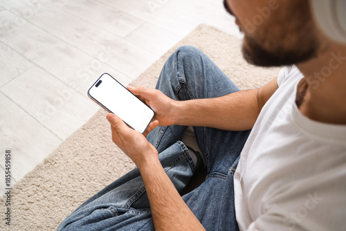 Young man with mobile phone...
