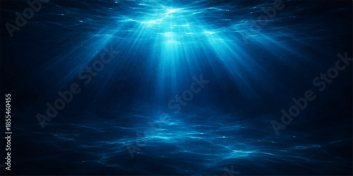 Deep blue sea background with bright underwater sun rays bursting through the water