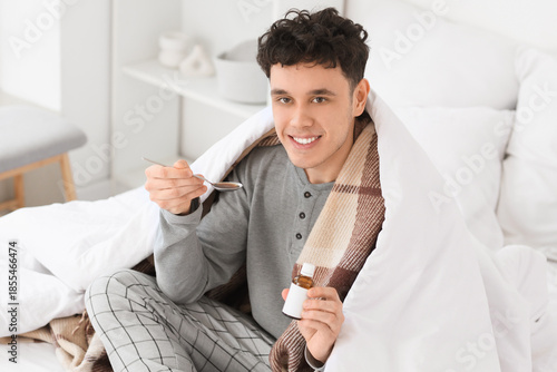 Ill young man with spoon an...