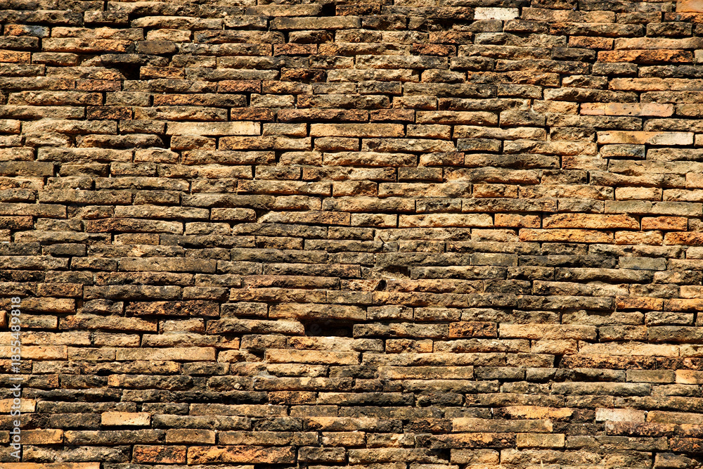 Obraz premium Detailed Textured Wall of Natural Stone Bricks in Warm Tones