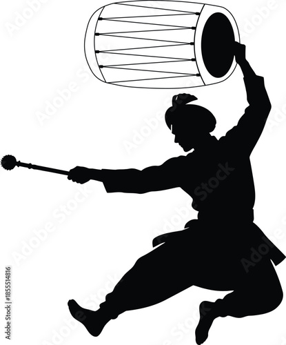 Dancer jumping with dhol drum in traditional bhangra pose