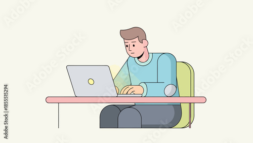 Young man working on laptop at desk in a modern home office setting