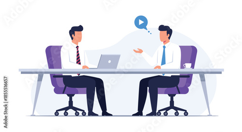 Two businessmen sitting at an office desk with a laptop, engaged in a professional conversation during a business meeting.