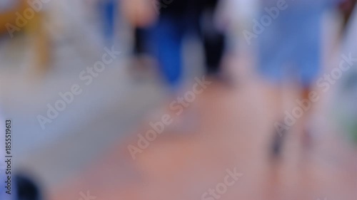 Wallpaper Mural A blurry image of people walking on a floor. The people are wearing different types of shoes, and some of them are carrying handbags. Scene is casual and relaxed Torontodigital.ca