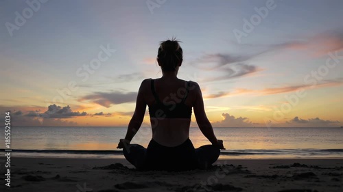 Silhouette of a person meditating on the beach at sunset, embracing peace and tranquility