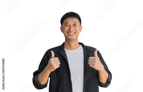 A young Asian man wearing black coat with a smile pointing thumbs up isolated on a white background. Well done. Agreement concept. Happy man