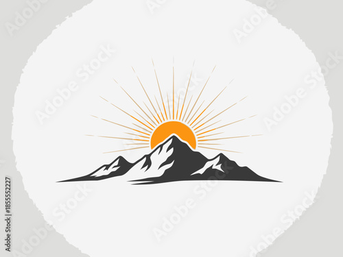 Sunrise over mountains with rays of light shining over the peaks