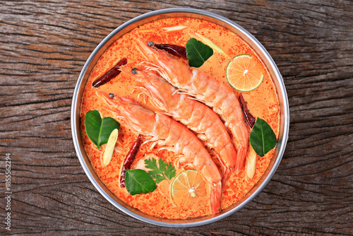 Tom Yum Kung or Tom Yum Goong a Spicy Sour Soup on wooden table top view, Food photography for use in menus