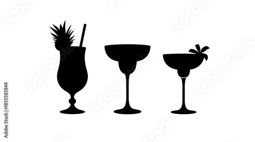 Three silhouette cocktail glasses with tropical garnish and straw