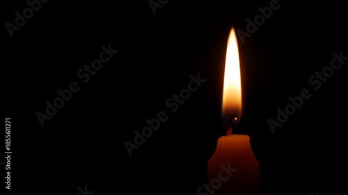 A calm candle flame drifts gently in open black space suggesting sorrow remembrance and the persistent weight of memory felt during reflective silence. Grief tribute.