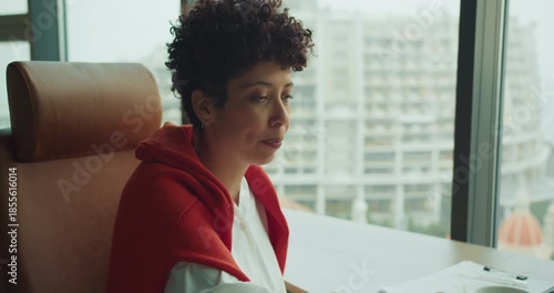 Serene woman taking mindful break during busy workday with scenic city view