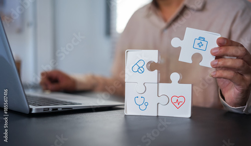 Businessman chooses a emoticon icons healthcare medical symbol on wooden block , Healthcare and medical Insurance concept 
