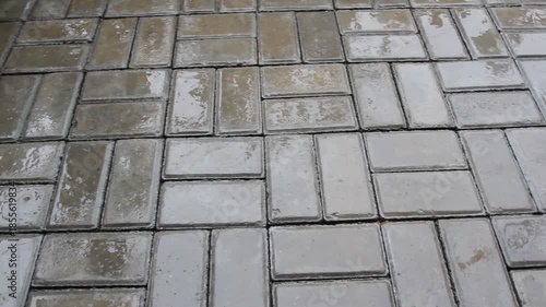 Wet concrete pavement surface when it rains.