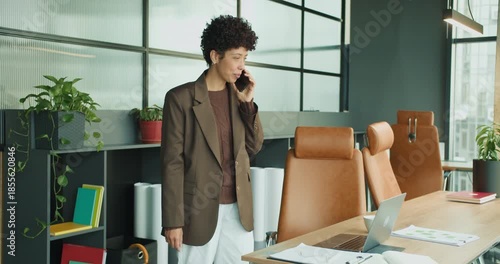 black project manager planning strategy on phone at desk