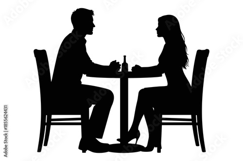 Couple silhouette enjoying a romantic dinner date seated at a small table together