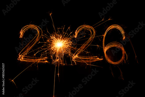 Happy New Year 2026 written sparkling sparklers isolated on black background with copy space for text.