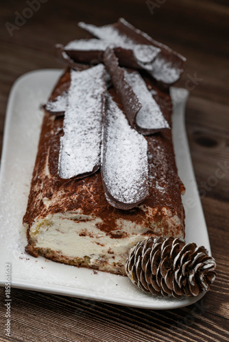 Tiramisu Tronchetto Dessert, Italian Yule Log Christmas dessert with chocolate bark, High quality photo