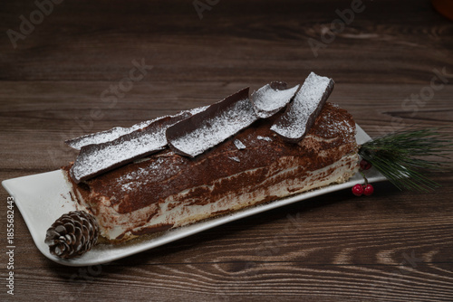 Tiramisu Tronchetto Dessert, Italian Yule Log Christmas dessert with chocolate bark, High quality photo