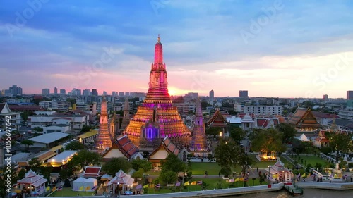 Orbit around illuminated Wat Arun Temple at Night