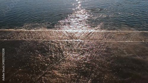 Sunlit Shallow Surf With Glittering Sparkle Across Water And Shoreline Cinematic Golden Light Hits Ripples And Foam, Creating Warm Radiance And Romantic Atmosphere Perfect For Summer, Travel