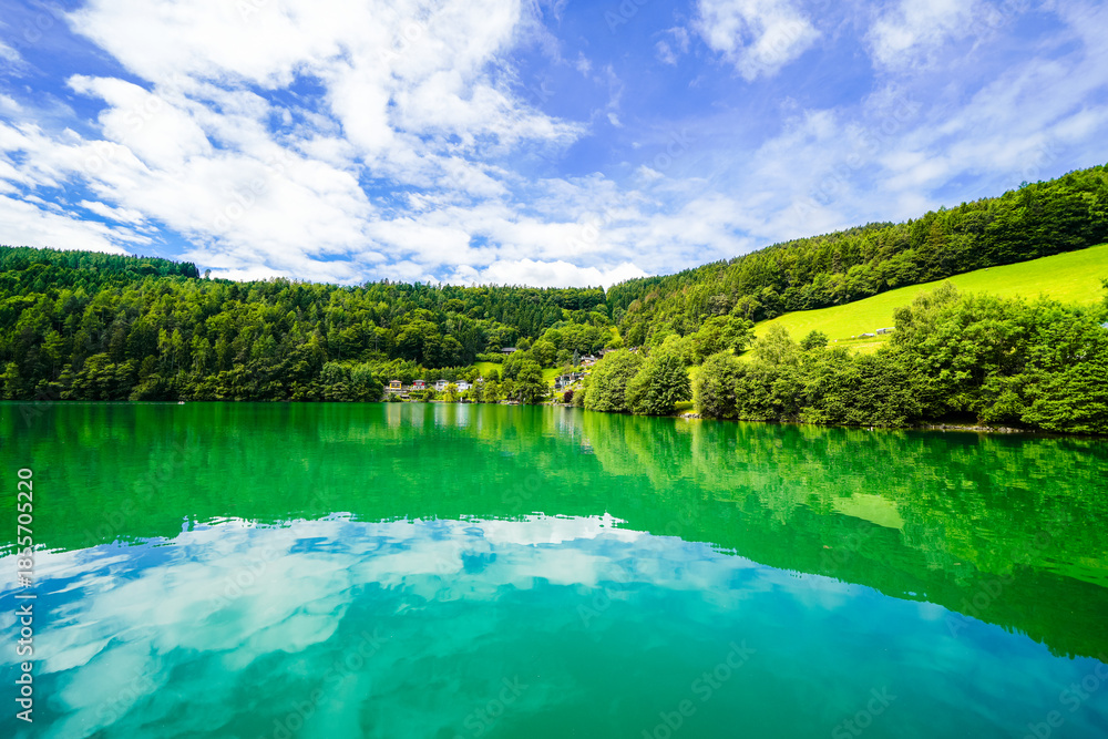 Fototapeta premium View of Lake Millstatt and the surrounding green landscape. Idyllic nature by the lake north of the Drava Valley near the town of Spittal an der Drau in Carinthia. 