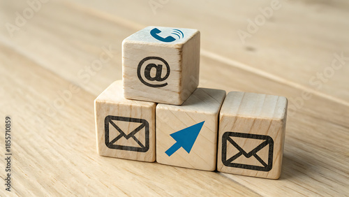 Wooden Blocks With Contact Icons Displayed Strategically on a Light Wood Surface Studio Shot