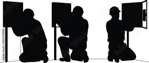Black silhouettes of electricians kneeling and working on electrical panels isolated on white background, maintenance and repair service vector illustration.