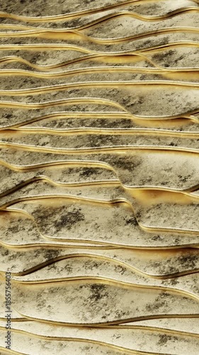 Close-up of abstract golden wave patterns on a textured surface Lines Smooth Curves. Concept featuring abstract, gold, wave patterns, textured surface, lines.