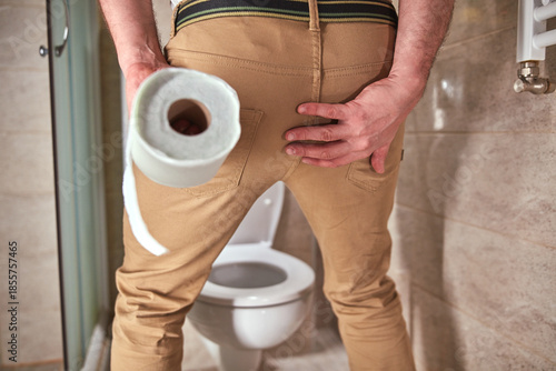 Man with urge to go to the toilet at home.