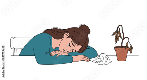 Sad young woman crying with her head on a table next to a crumpled tissue and a dying potted plant, expressing grief.