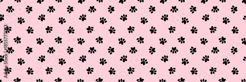 Seamless pattern of black cat or dog paw prints with heart shapes on a pastel pink background. Minimalist animal footprint wallpaper for pet-themed designs, textile, wrapping paper, and scrapbooking.
