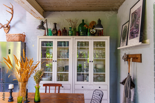 Kitchen with glassware and green decor in country home